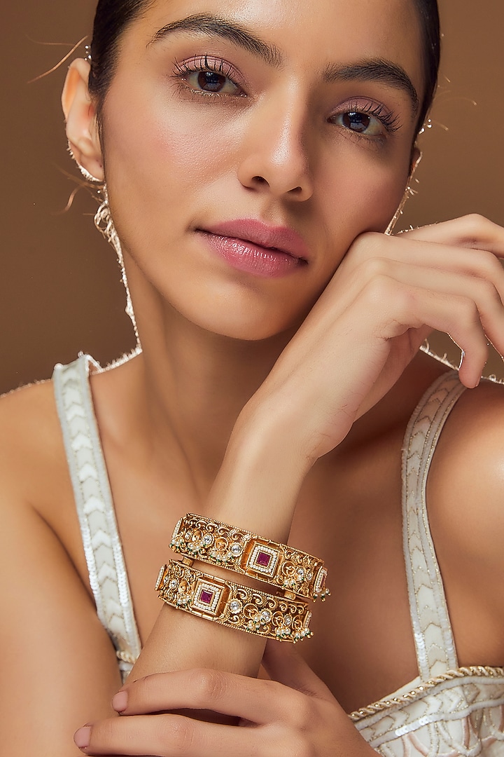 Gold Finish Kundan Polki & Red Stone Temple Bangles (Set Of 2) by VASTRAA Jewellery at Pernia's Pop Up Shop