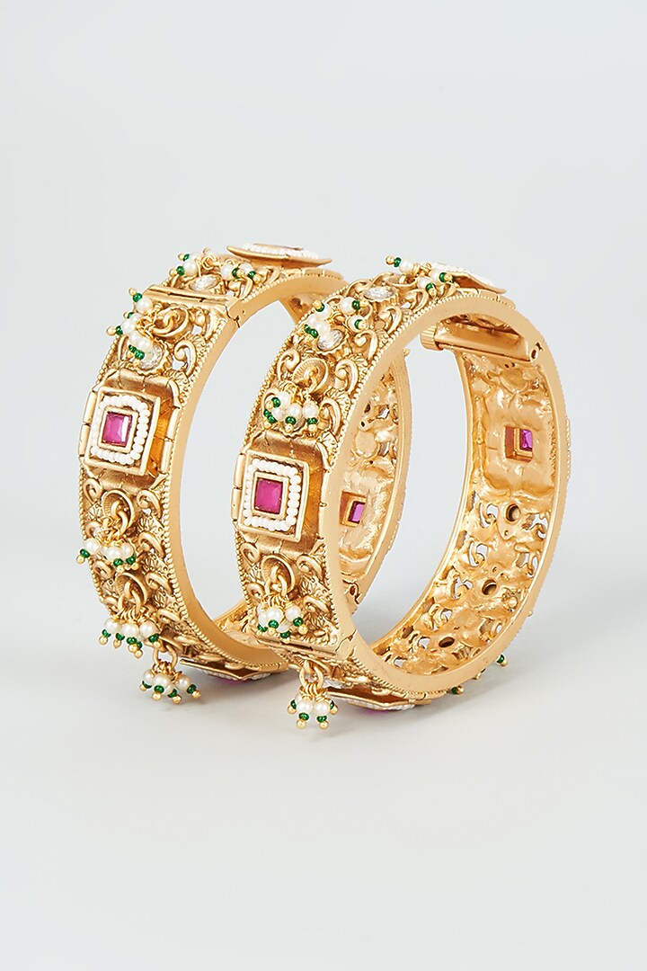 Gold Finish Kundan Polki & Red Stone Temple Bangles (Set Of 2) by VASTRAA Jewellery at Pernia's Pop Up Shop
