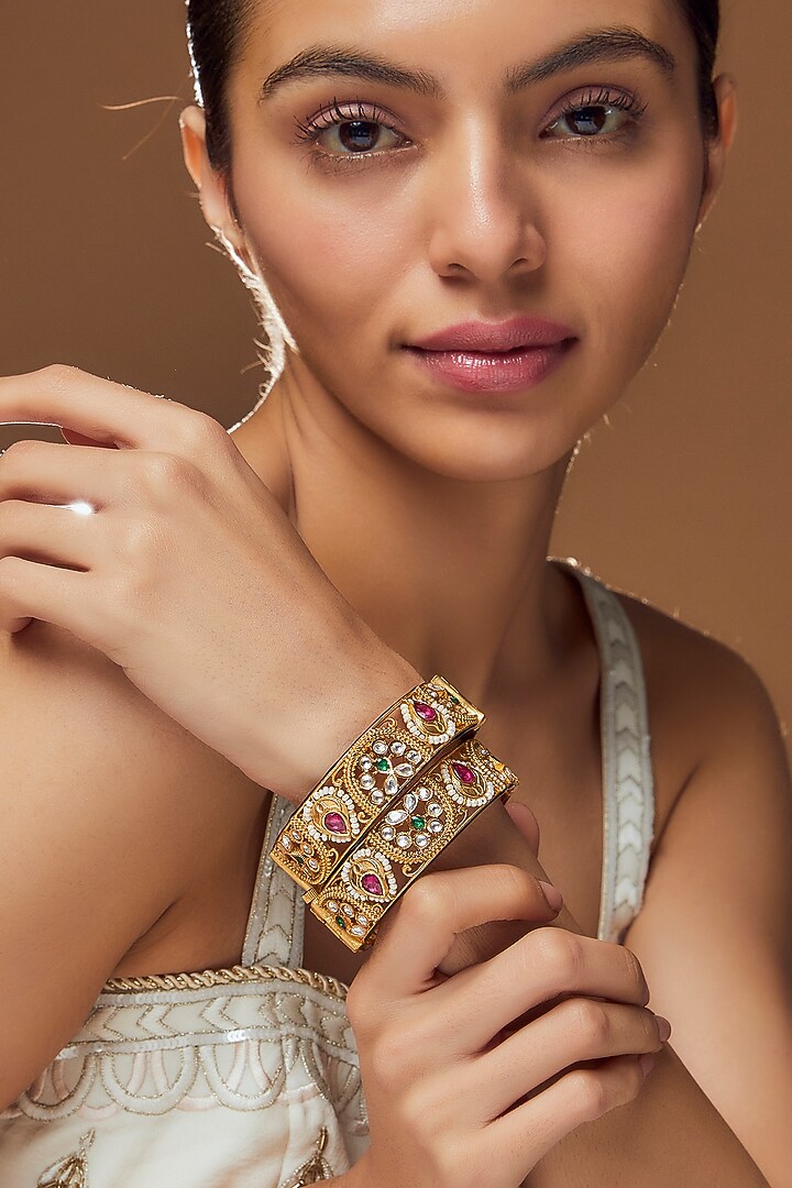 Gold Finish Kundan Polki & Multi-Colored Stone Bangles (Set Of 2) by VASTRAA Jewellery at Pernia's Pop Up Shop