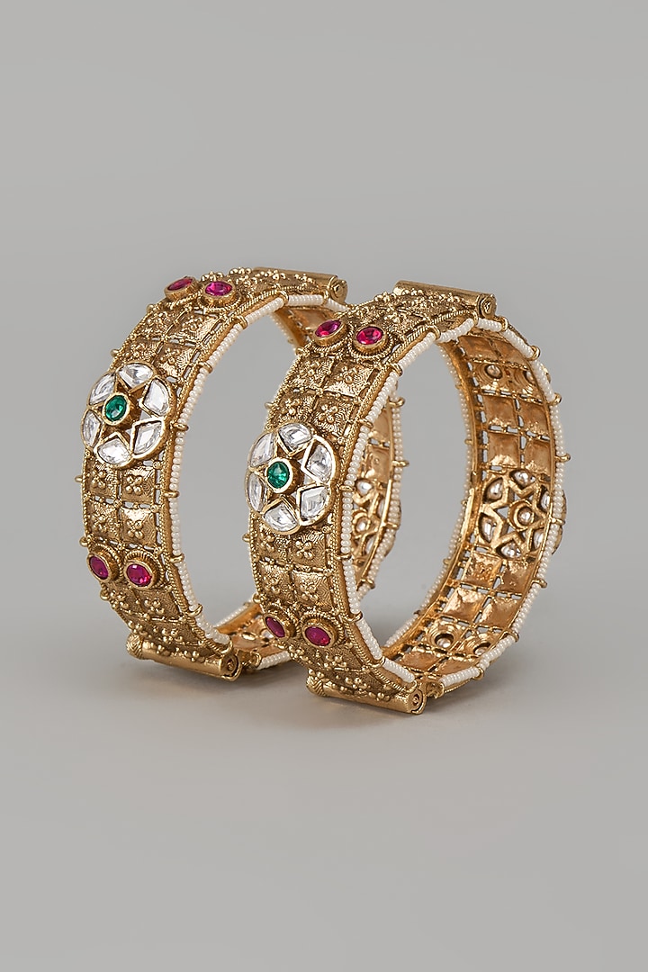 Gold Finish Kundan Polki & Multi-Colored Stone Temple Bangles (Set Of 2) by VASTRAA Jewellery at Pernia's Pop Up Shop