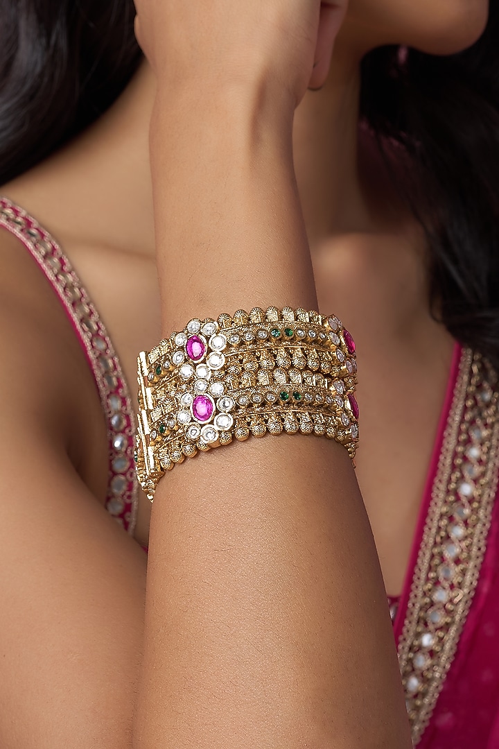 Gold Finish Kundan Polki & Red Stone Temple Bangles (Set Of 2) by VASTRAA Jewellery at Pernia's Pop Up Shop