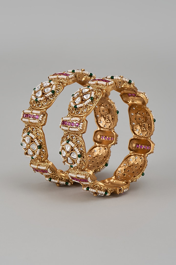 Gold Finish Kundan Polki & Multi-Colored Stone Temple Bangles (Set Of 2) by VASTRAA Jewellery at Pernia's Pop Up Shop