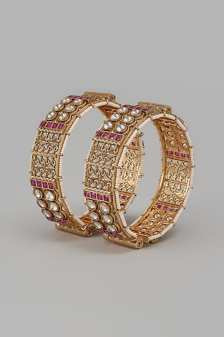 Gold Finish Kundan Polki & Red Stone Temple Bangles (Set Of 2) by VASTRAA Jewellery at Pernia's Pop Up Shop