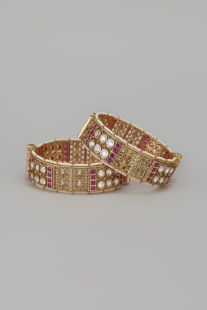 Gold Finish Kundan Polki & Red Stone Temple Bangles (Set Of 2) by VASTRAA Jewellery at Pernia's Pop Up Shop