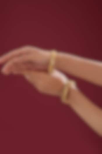 Gold Finish Kundan Polki & Multi-Colored Stone Temple Bangles (Set Of 2) by VASTRAA Jewellery at Pernia's Pop Up Shop