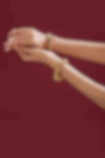 Gold Finish Kundan Polki & Red Stone Bangles (Set Of 2) by VASTRAA Jewellery at Pernia's Pop Up Shop