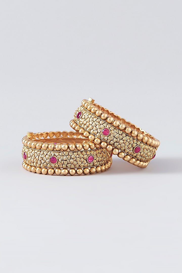Gold Finish Kundan Polki & Red Stone Bangles (Set Of 2) by VASTRAA Jewellery at Pernia's Pop Up Shop
