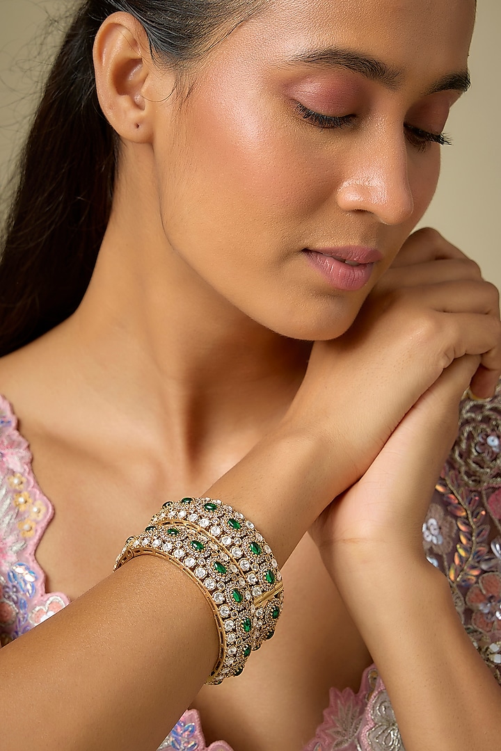 Gold Finish Kundan Polki & Emerald Stone Bangles (Set Of 2) by VASTRAA Jewellery at Pernia's Pop Up Shop