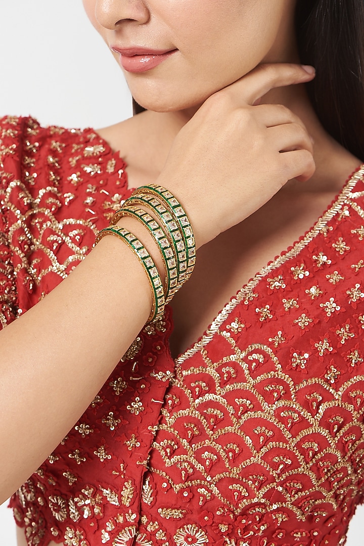 Gold Finish Kundan Polki Green Enameled Bangles (Set Of 4) by VASTRAA Jewellery at Pernia's Pop Up Shop