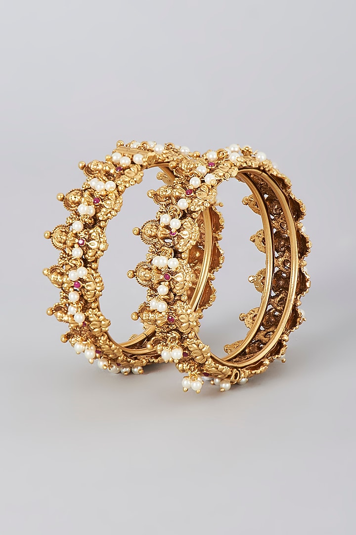 Gold Finish Pearl Temple Bangles (Set Of 2) by VASTRAA Jewellery at Pernia's Pop Up Shop