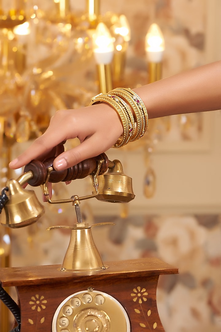 Gold Finish Kundan Polki Temple Bangles (Set Of 2) by VASTRAA Jewellery at Pernia's Pop Up Shop