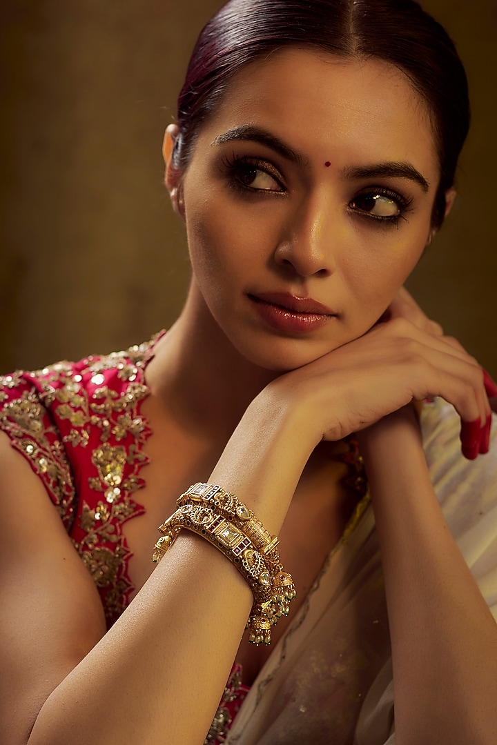 Gold Finish Kundan Polki & Multi-Colored Stone Temple Bangles (Set of 2) by VASTRAA Jewellery at Pernia's Pop Up Shop