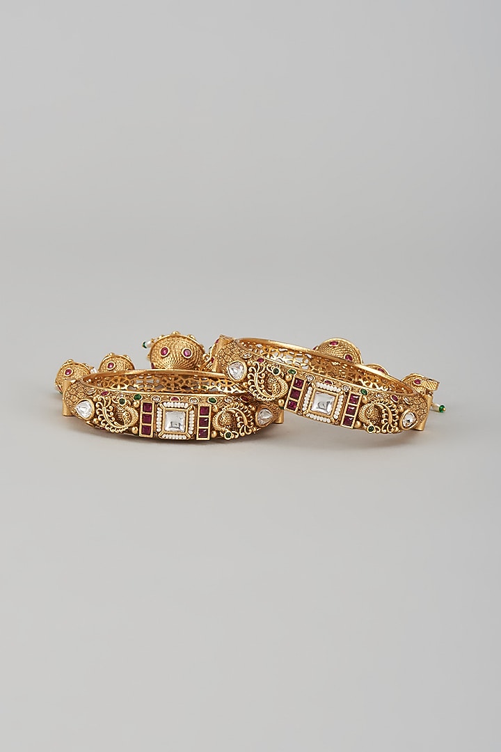 Gold Finish Kundan Polki & Multi-Colored Stone Temple Bangles (Set of 2) by VASTRAA Jewellery at Pernia's Pop Up Shop