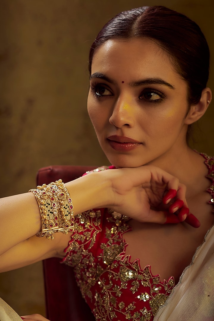 Gold Finish Kundan Polki & Multi-Colored Stone Temple Bangles (Set of 2) by VASTRAA Jewellery at Pernia's Pop Up Shop