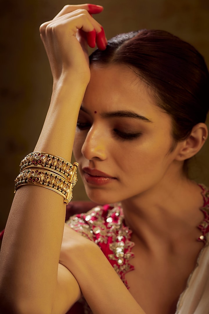Gold Finish Kundan Polki & Multi-Colored Stone Temple Bangles (Set of 2) by VASTRAA Jewellery at Pernia's Pop Up Shop