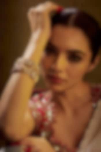 Gold Finish Kundan Polki & Multi-Colored Stone Temple Bangles (Set of 2) by VASTRAA Jewellery at Pernia's Pop Up Shop