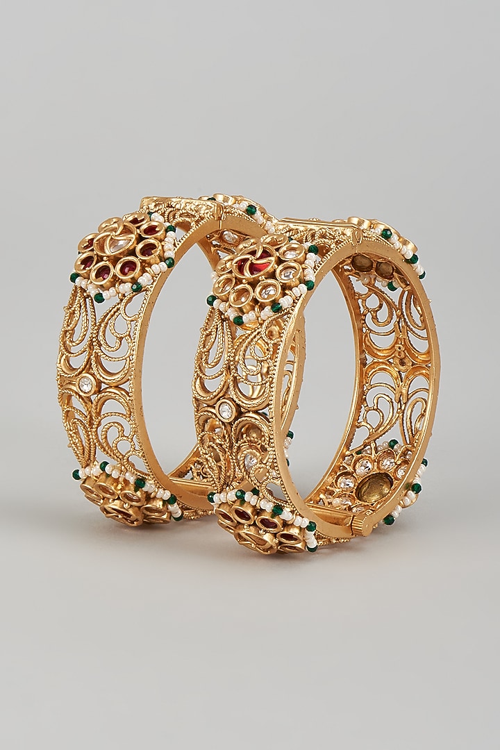 Gold Finish Kundan Polki & Multi-Colored Stone Temple Bangles (Set of 2) by VASTRAA Jewellery at Pernia's Pop Up Shop