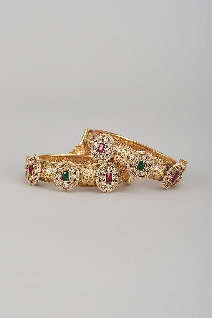 Gold Finish Kundan Polki & Multi-Colored Stone Temple Bangles (Set of 2) by VASTRAA Jewellery at Pernia's Pop Up Shop