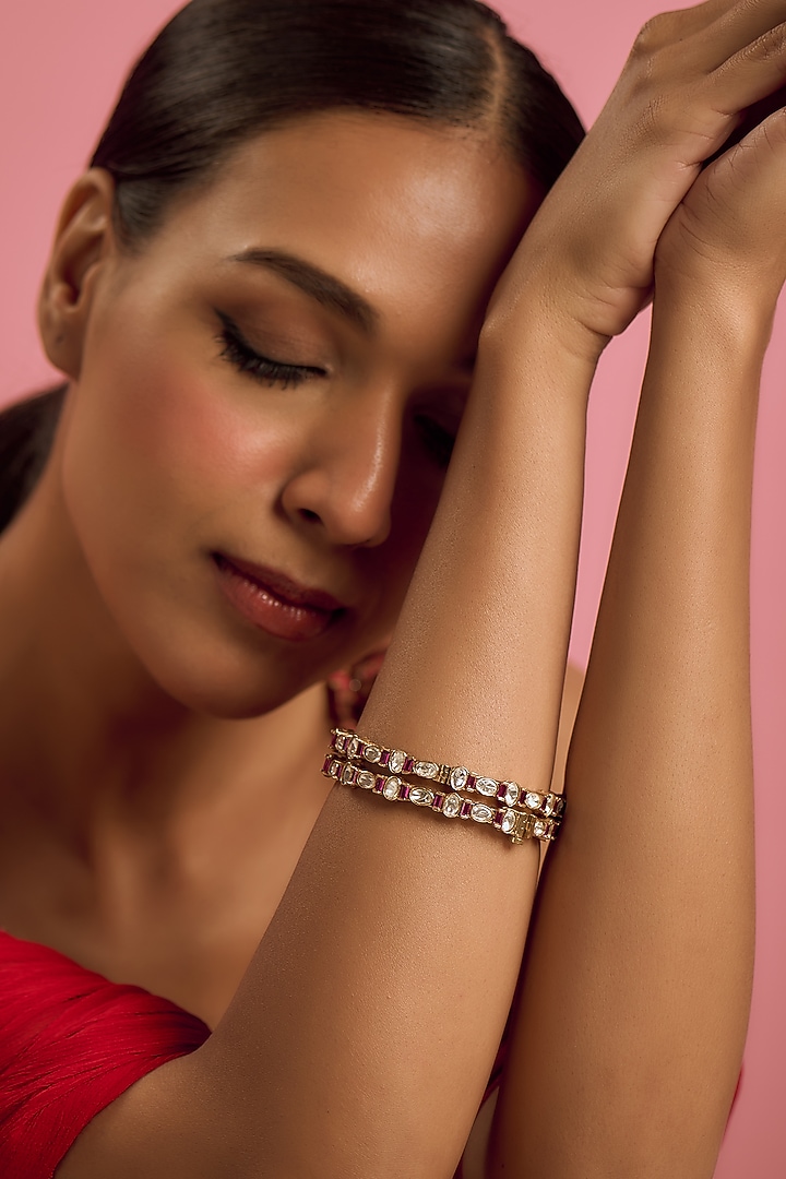 Gold Finish Kundan Polki & Ruby Bangles (Set Of 2) by VASTRAA Jewellery at Pernia's Pop Up Shop