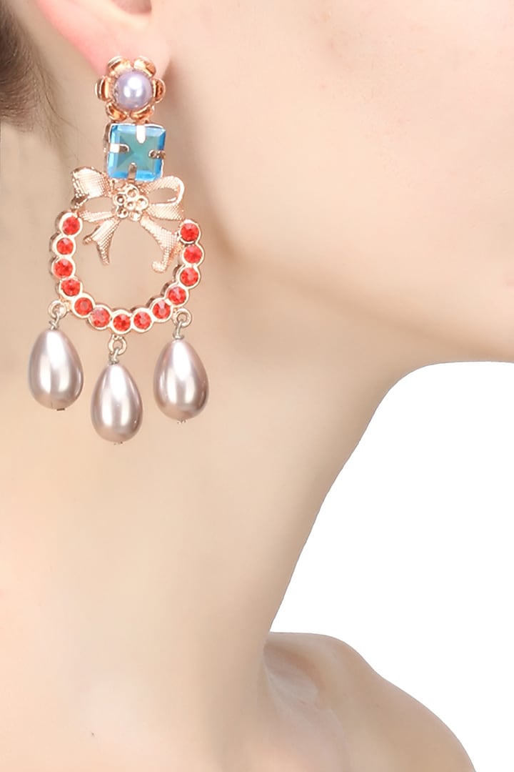 Gold finish pearl and semi precious stone bow earrings by Valliyan By Nitya Arora