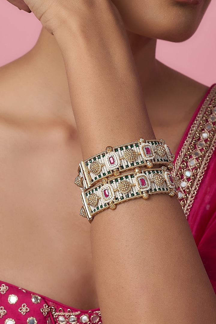 Gold Finish Kundan Polki & Multi-Colored Stone Temple Bangles (Set Of 2) by VASTRAA Jewellery at Pernia's Pop Up Shop