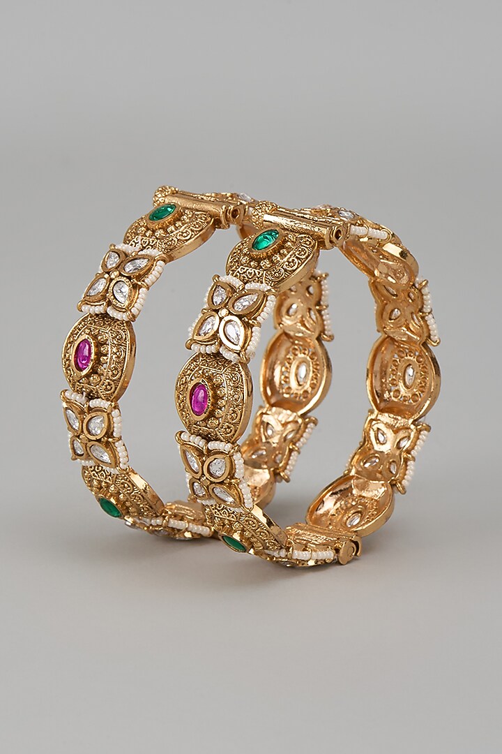 Gold Finish Kundan Polki & Multi-Colored Stone Temple Bangles (Set Of 2) by VASTRAA Jewellery at Pernia's Pop Up Shop