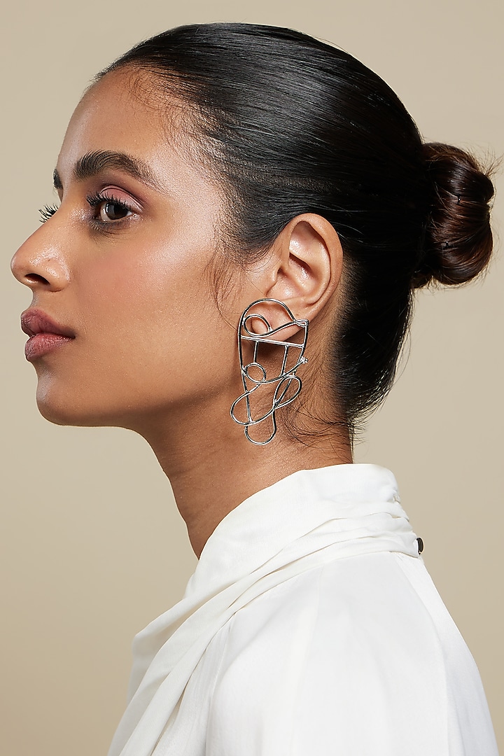 Silver Plated Metal Twisted Earrings by Valliyan By Nitya Arora