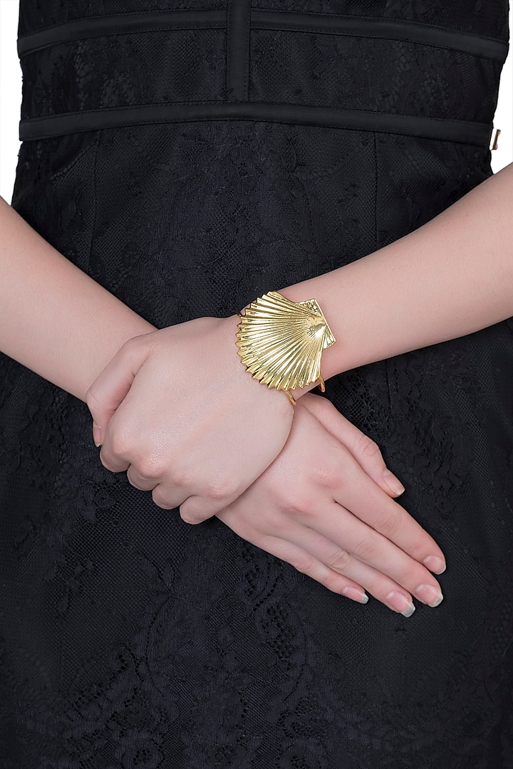 Gold plated shell cuff by Valliyan by Nitya Arora