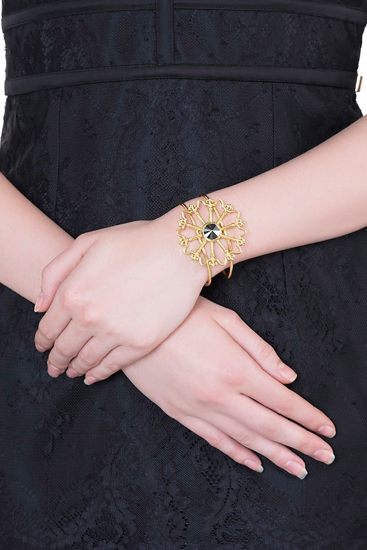 Gold plated stone floral cuff by Valliyan by Nitya Arora