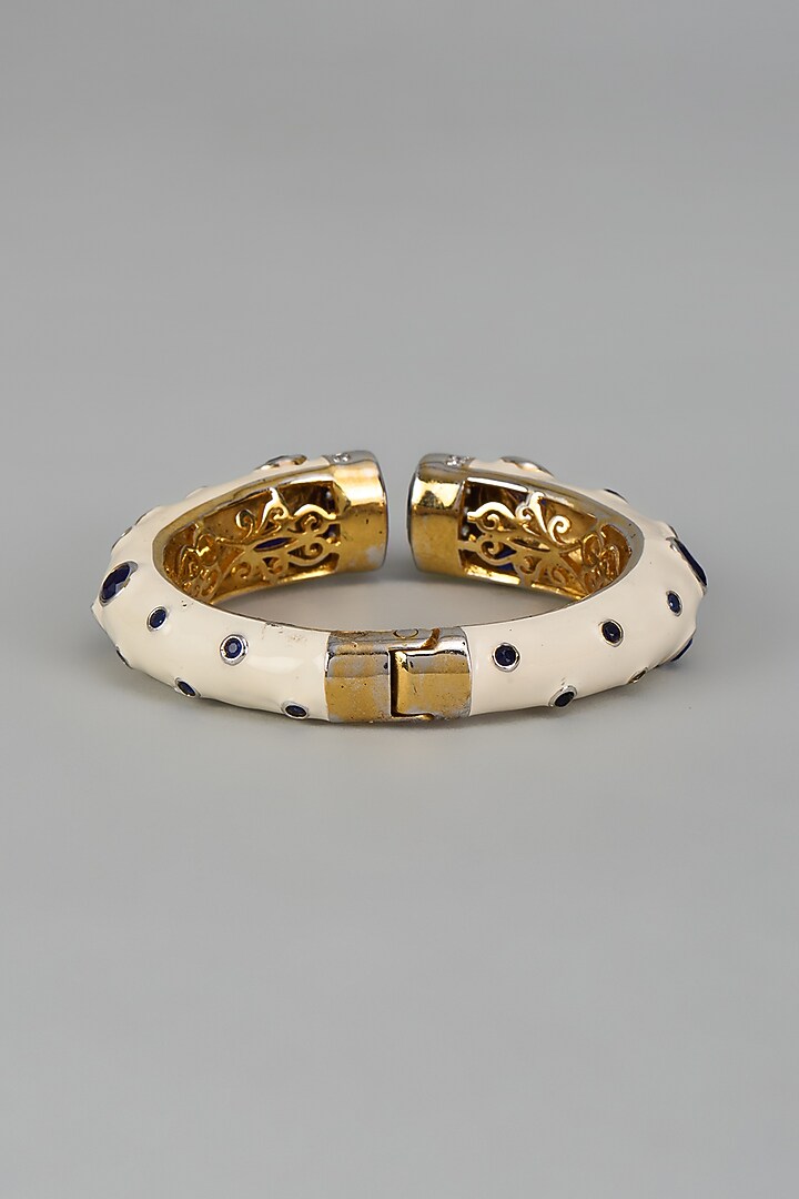 Gold Finish Sapphire Synthetic Stone Enameled Bangle by Vivinia By Vidhi Mehra at Pernia's Pop Up Shop
