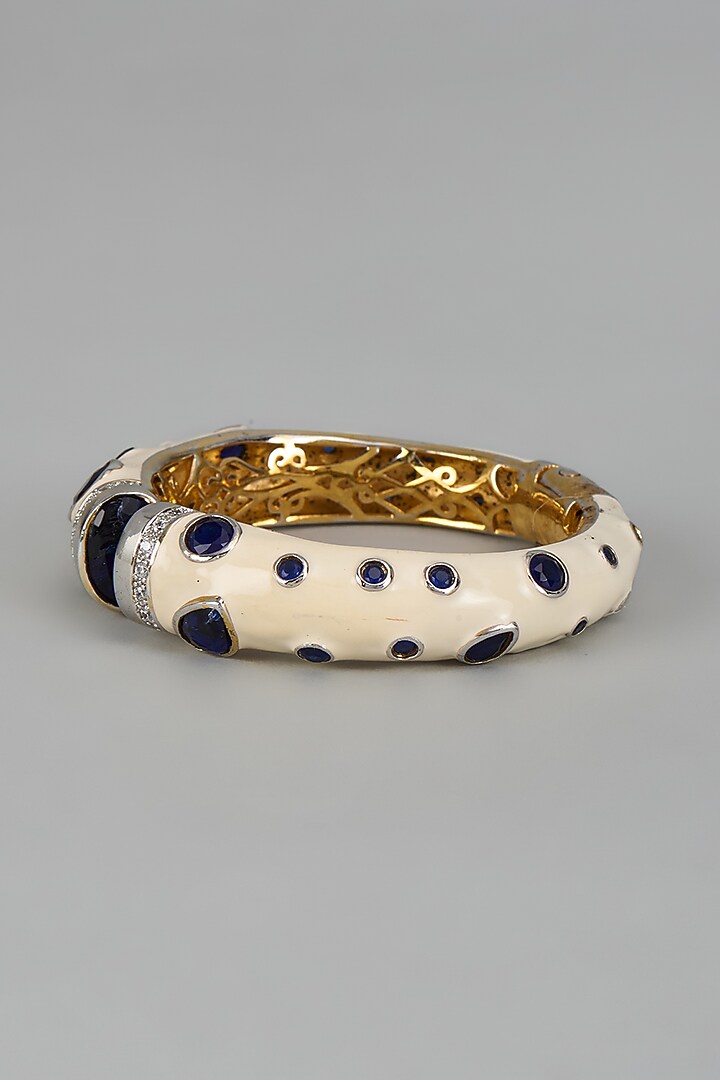 Gold Finish Sapphire Synthetic Stone Enameled Bangle by Vivinia By Vidhi Mehra at Pernia's Pop Up Shop