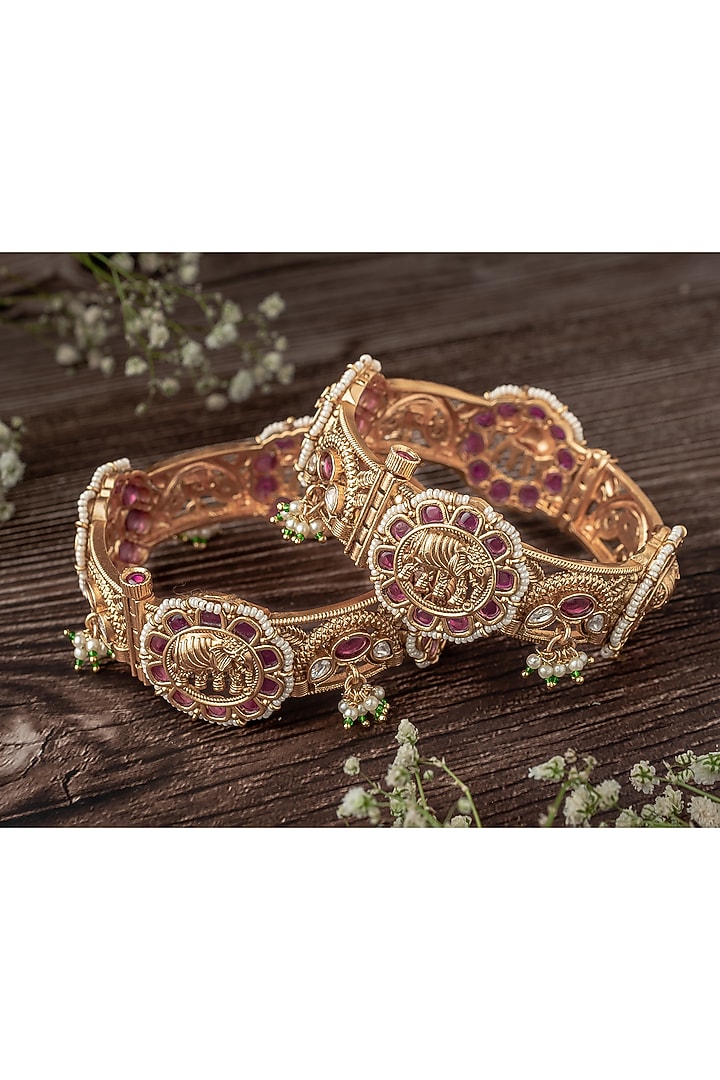 Gold Finish Pink & Green Gemstone Temple Bangles (Set Of 2) by Vivinia By Vidhi Mehra at Pernia's Pop Up Shop
