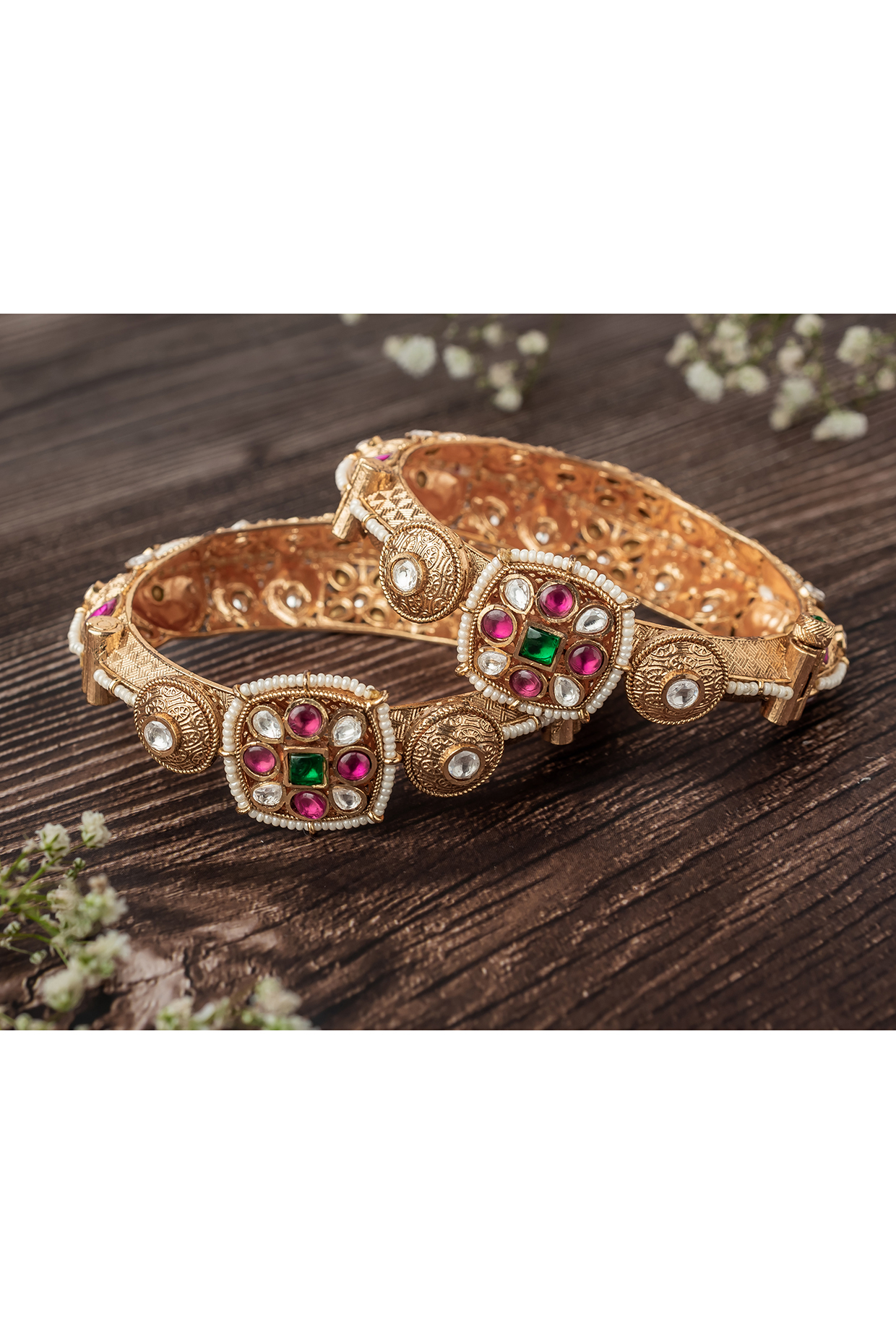 Gold Finish Ruby & Emerald Stone Floral Motif Bangles (Set Of 2) by Vivinia By Vidhi Mehra at Pernia's Pop Up Shop