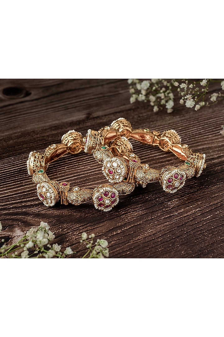 Gold Finish Ruby Stone & Diamond Floral Motif Bangles (Set Of 2) by Vivinia By Vidhi Mehra at Pernia's Pop Up Shop