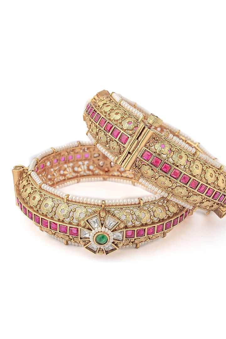 Gold Finish Green & Pink Stone Temple Floral Bangles (Set Of 2) by Vivinia By Vidhi Mehra at Pernia's Pop Up Shop