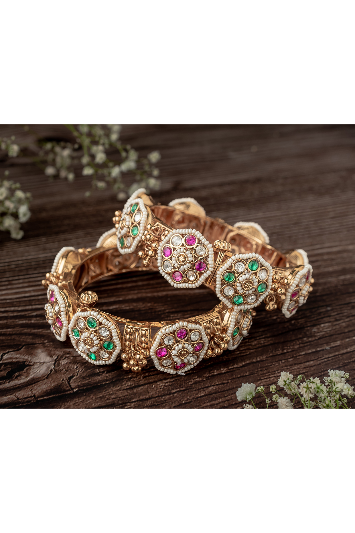 Gold Finish Kundan Polki & Pink Gemstone Floral Bangles (Set Of 2) by Vivinia By Vidhi Mehra at Pernia's Pop Up Shop