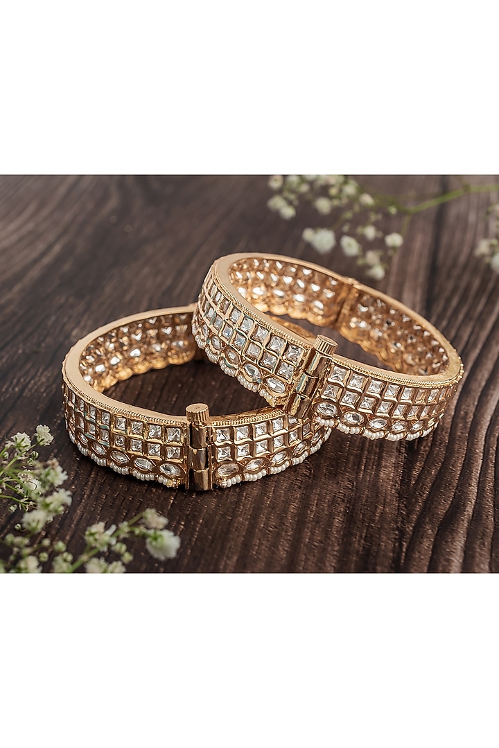 Gold Finish Kundan Polki & White Stone Floral Bangles (Set Of 2) by Vivinia By Vidhi Mehra at Pernia's Pop Up Shop