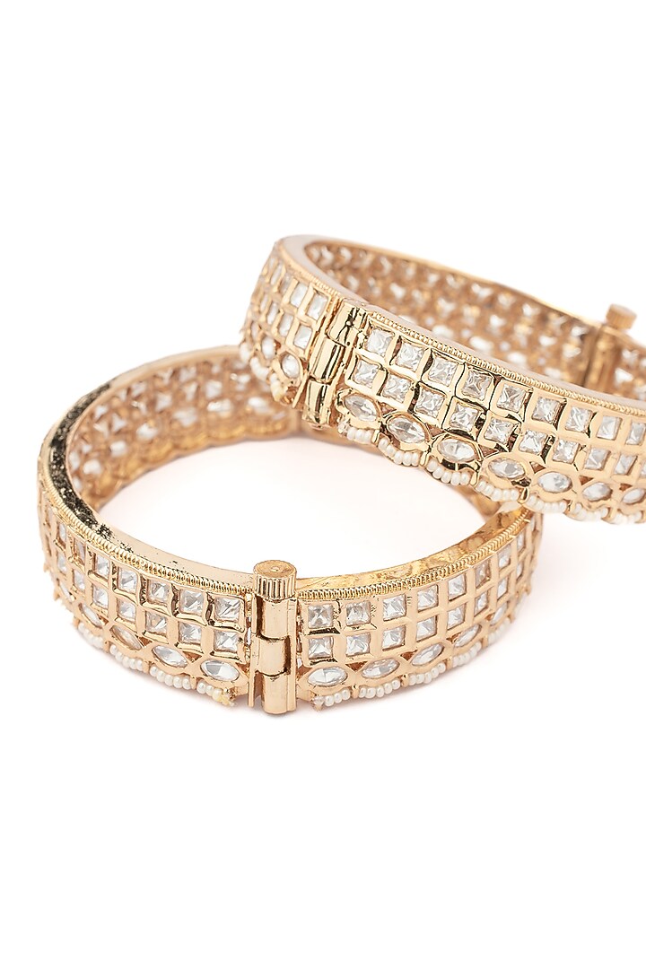 Gold Finish Kundan Polki & White Stone Floral Bangles (Set Of 2) by Vivinia By Vidhi Mehra at Pernia's Pop Up Shop