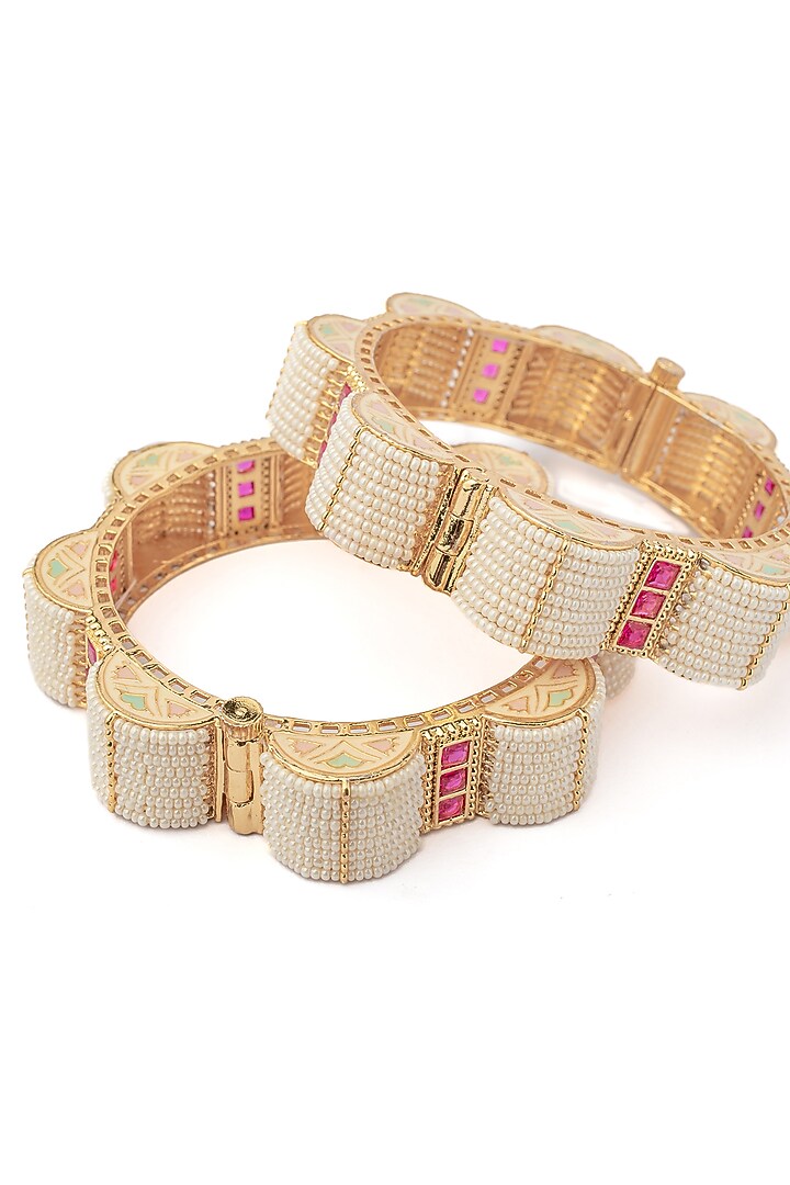 Gold Finish Pink Stones & White Beaded Bangles (Set Of 2) by Vivinia By Vidhi Mehra at Pernia's Pop Up Shop