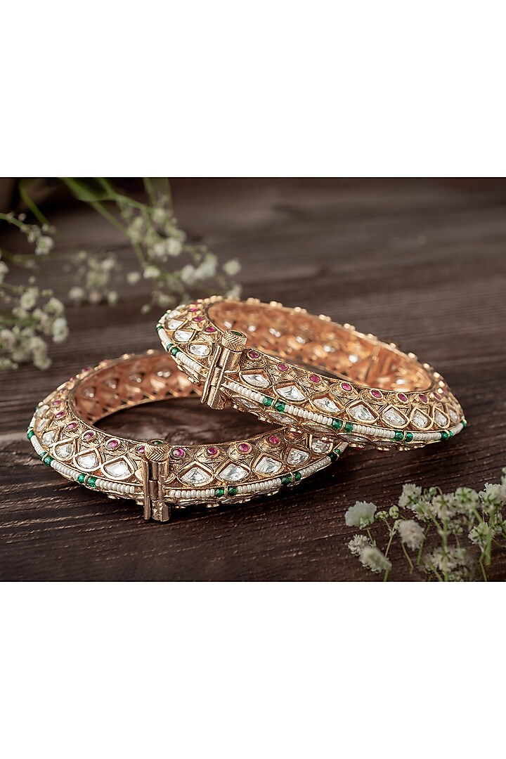 Gold Finish White Tear-Drop Shaped Stone Enameled Bangles (Set Of 2) by Vivinia By Vidhi Mehra at Pernia's Pop Up Shop