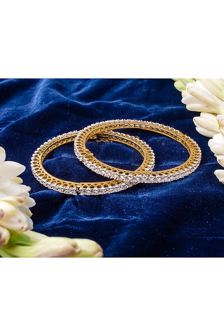 Gold Finish Cubic Zirconia Bangles (Set Of 2) by Vivinia By Vidhi Mehra at Pernia's Pop Up Shop