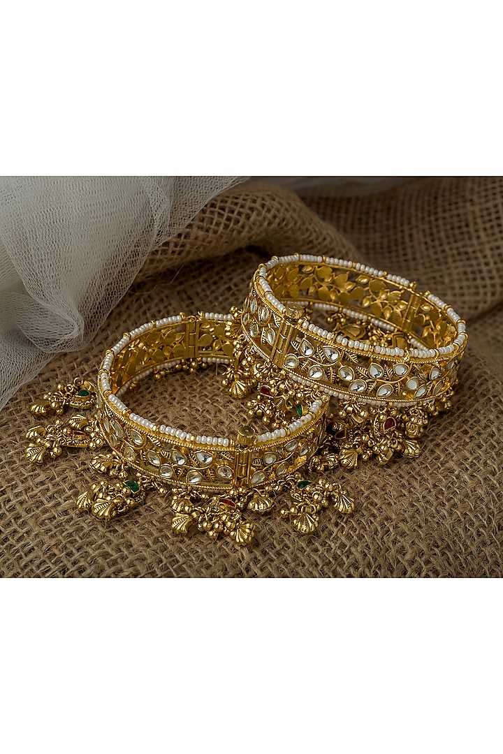 Gold Finish Kundan Polki Bangles (Set Of 2) by Vivinia By Vidhi Mehra at Pernia's Pop Up Shop