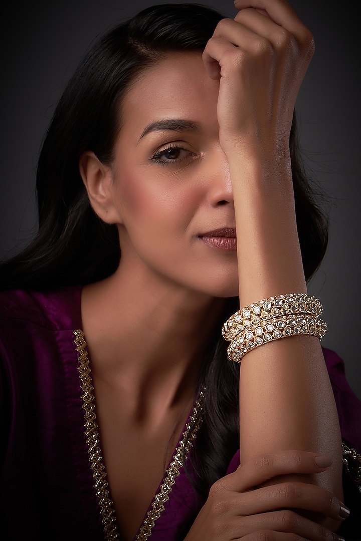Gold Finish White Kundan Polki Bangles (Set of 2) by Vivinia By Vidhi Mehra at Pernia's Pop Up Shop