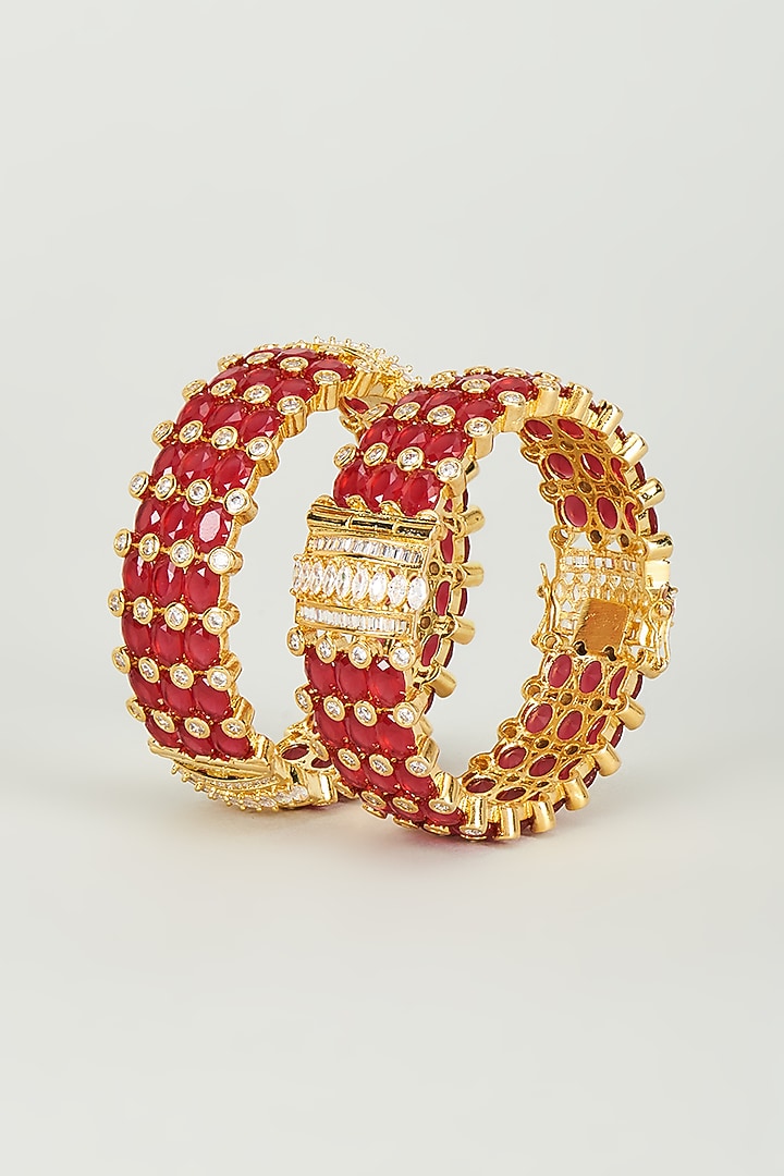 Gold Finish Red Synthetic Stones Bangles (Set of 2) by Vivinia By Vidhi Mehra at Pernia's Pop Up Shop
