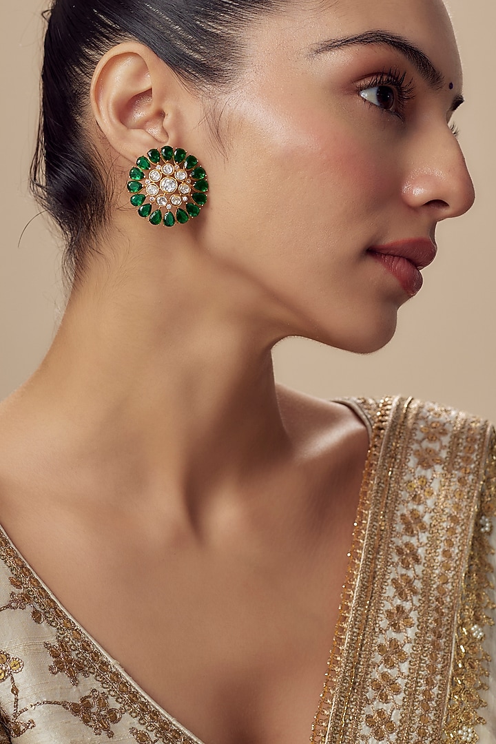 Gold Finish Moissanite Polki & Emerald Green Stone Stud Earrings by Vivinia By Vidhi Mehra at Pernia's Pop Up Shop