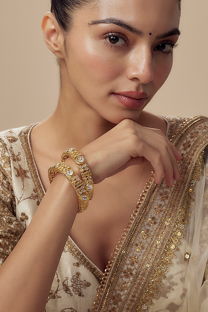 Gold Finish Kundan Polki Bangles (Set Of 2) by Vivinia By Vidhi Mehra at Pernia's Pop Up Shop
