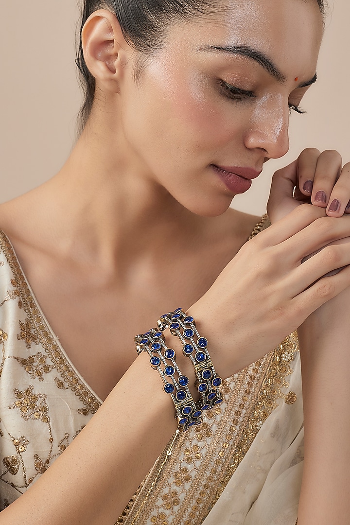 Gold Finish Blue Diamond Beaded Bangles (Set Of 2) by Vivinia By Vidhi Mehra at Pernia's Pop Up Shop