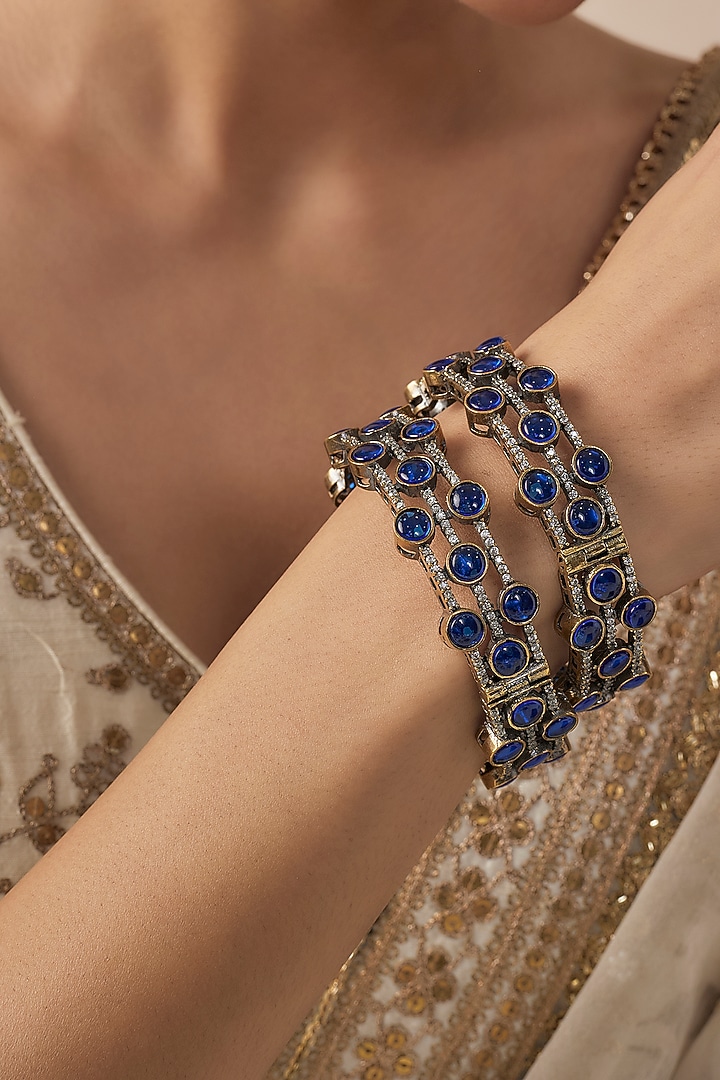 Gold Finish Blue Diamond Beaded Bangles (Set Of 2) by Vivinia By Vidhi Mehra at Pernia's Pop Up Shop