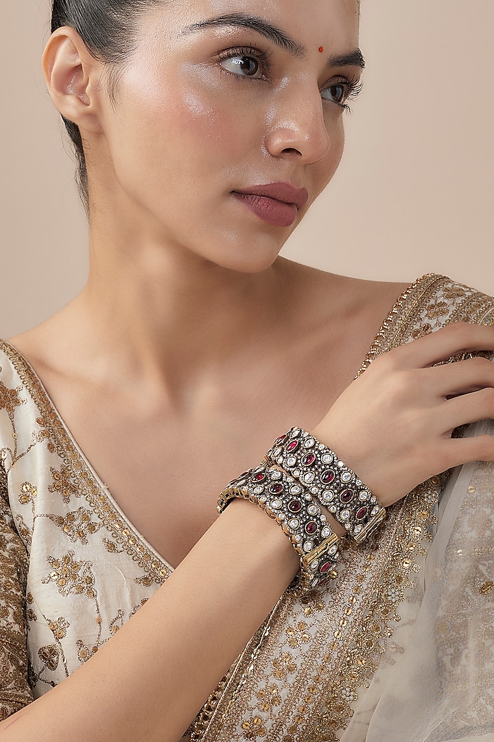 Gold Finish Kundan Polki & Ruby Stone Bangles (Set Of 2) by Vivinia By Vidhi Mehra at Pernia's Pop Up Shop