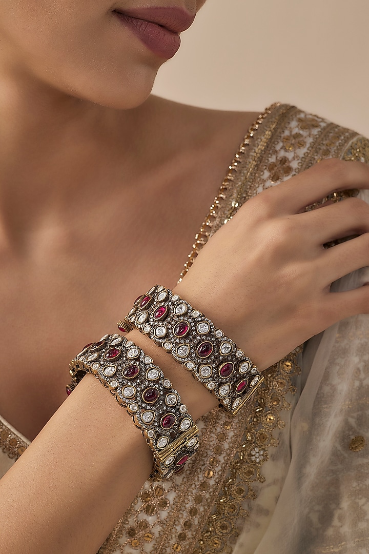 Gold Finish Kundan Polki & Ruby Stone Bangles (Set Of 2) by Vivinia By Vidhi Mehra at Pernia's Pop Up Shop